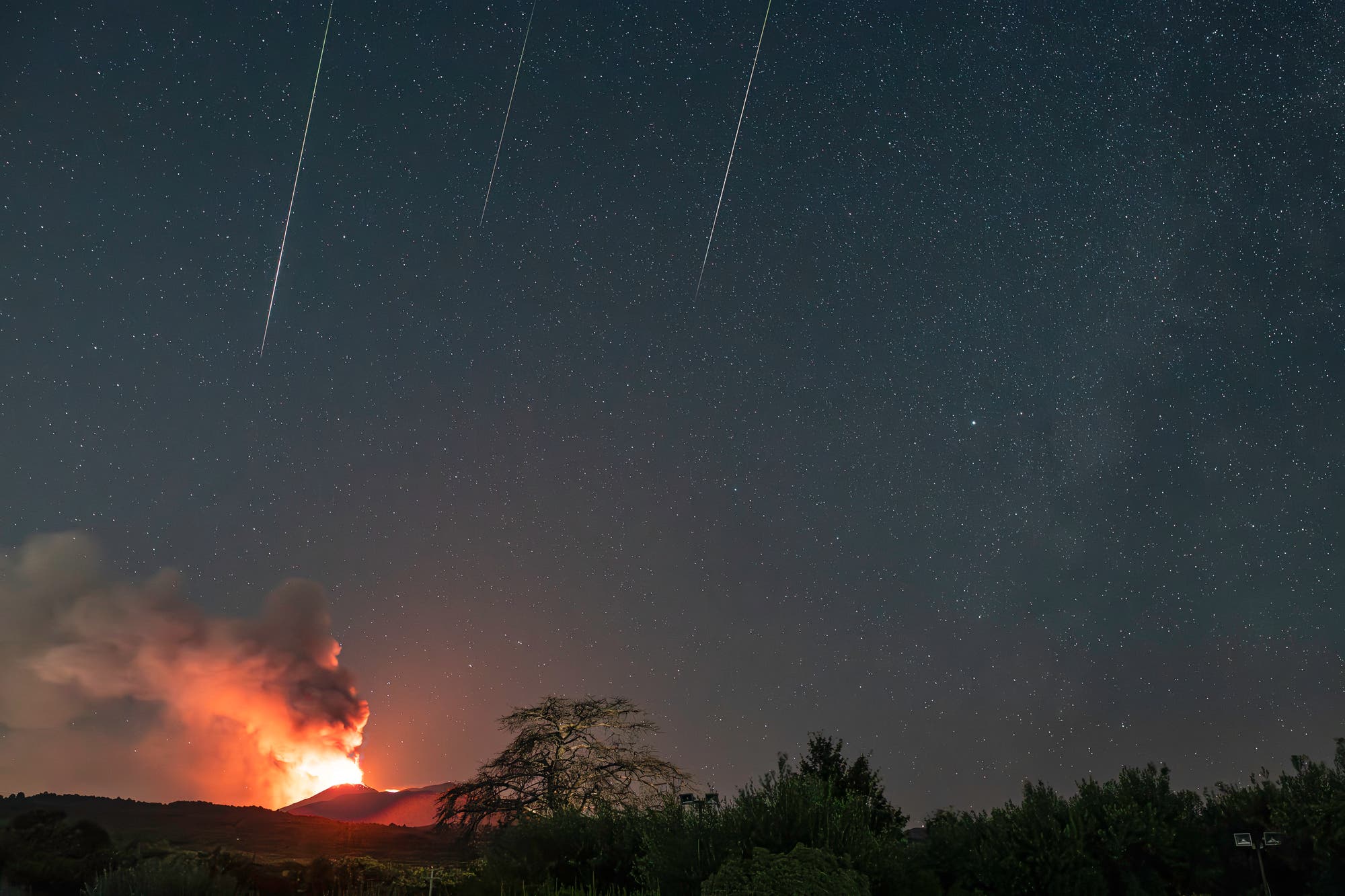 Three Perseids straight on erupting Etna