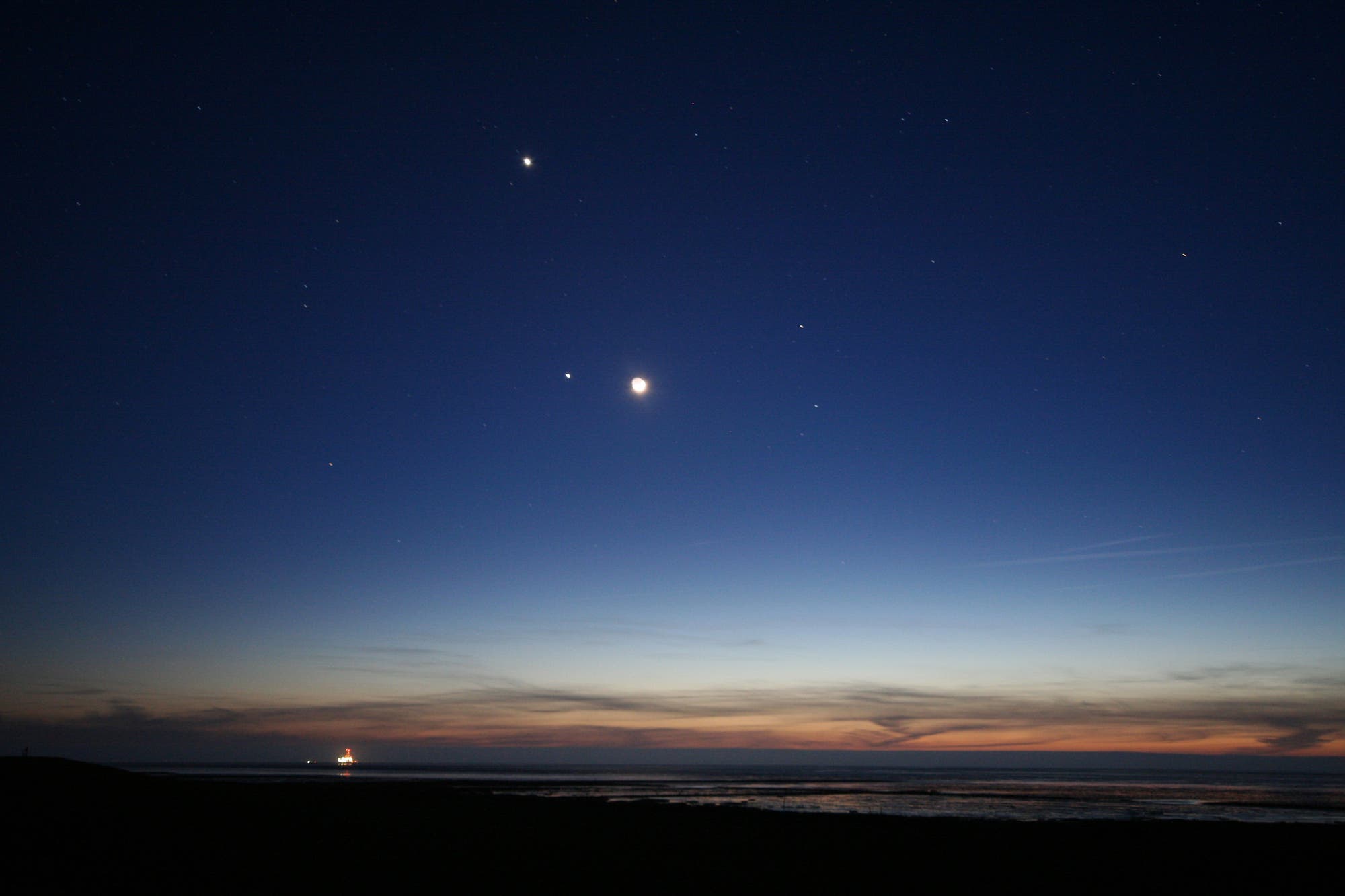 Venus, Jupiter und Mond über dem Watt