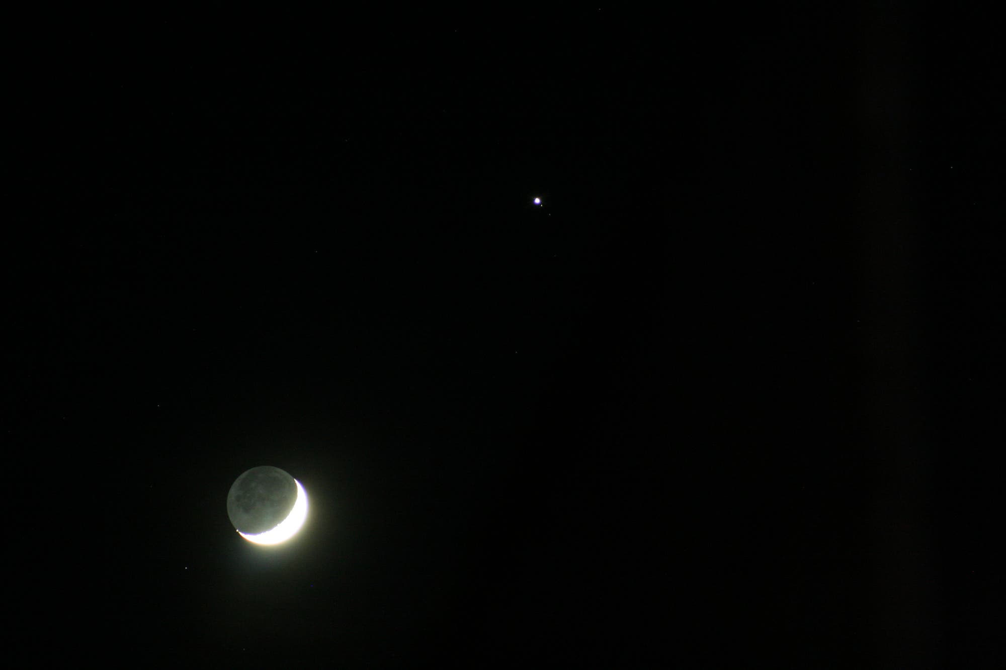 Mond im aschgrauen Licht mit Jupiter