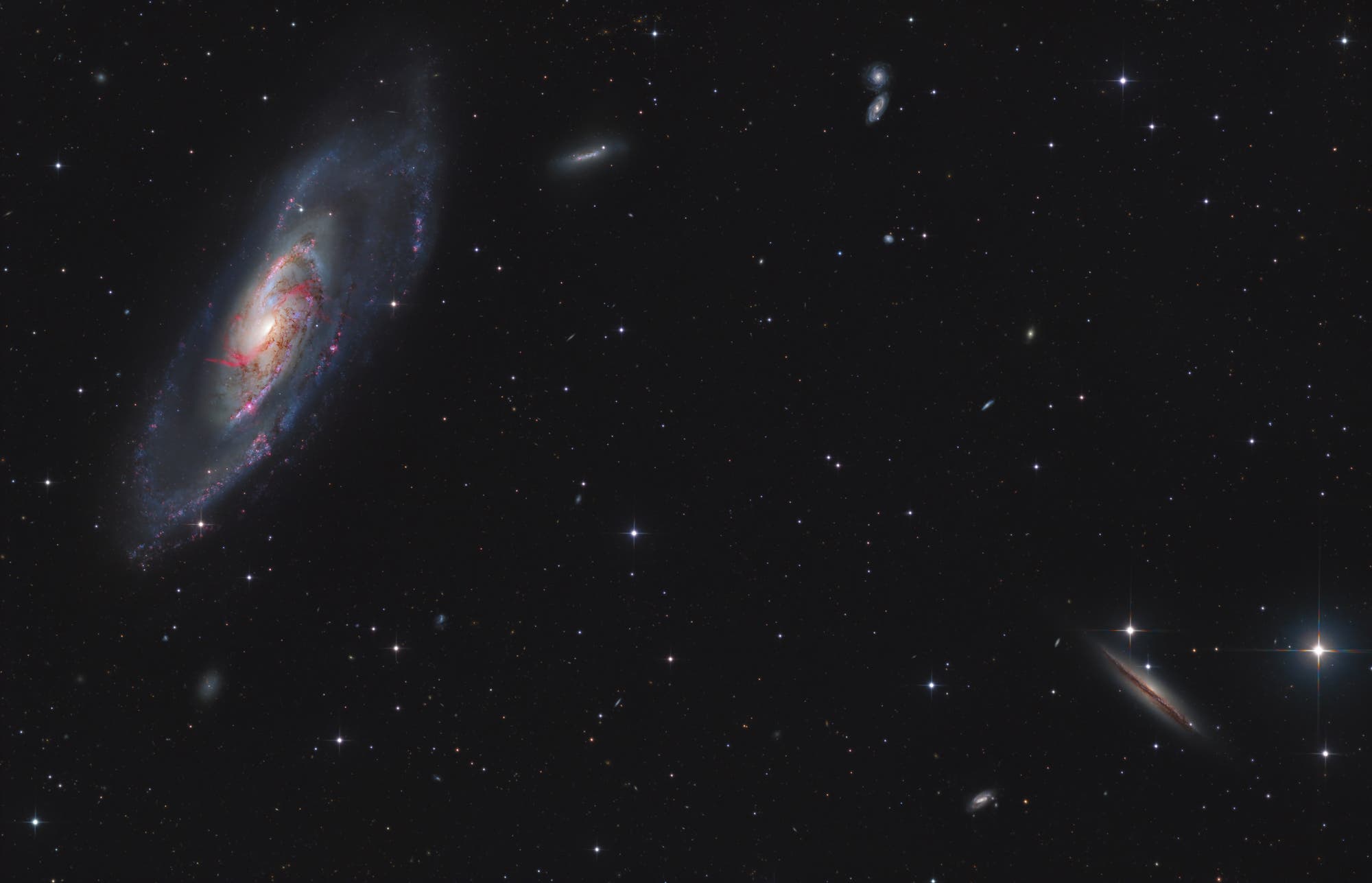 Messier 106 und seine kosmischen Geschwister