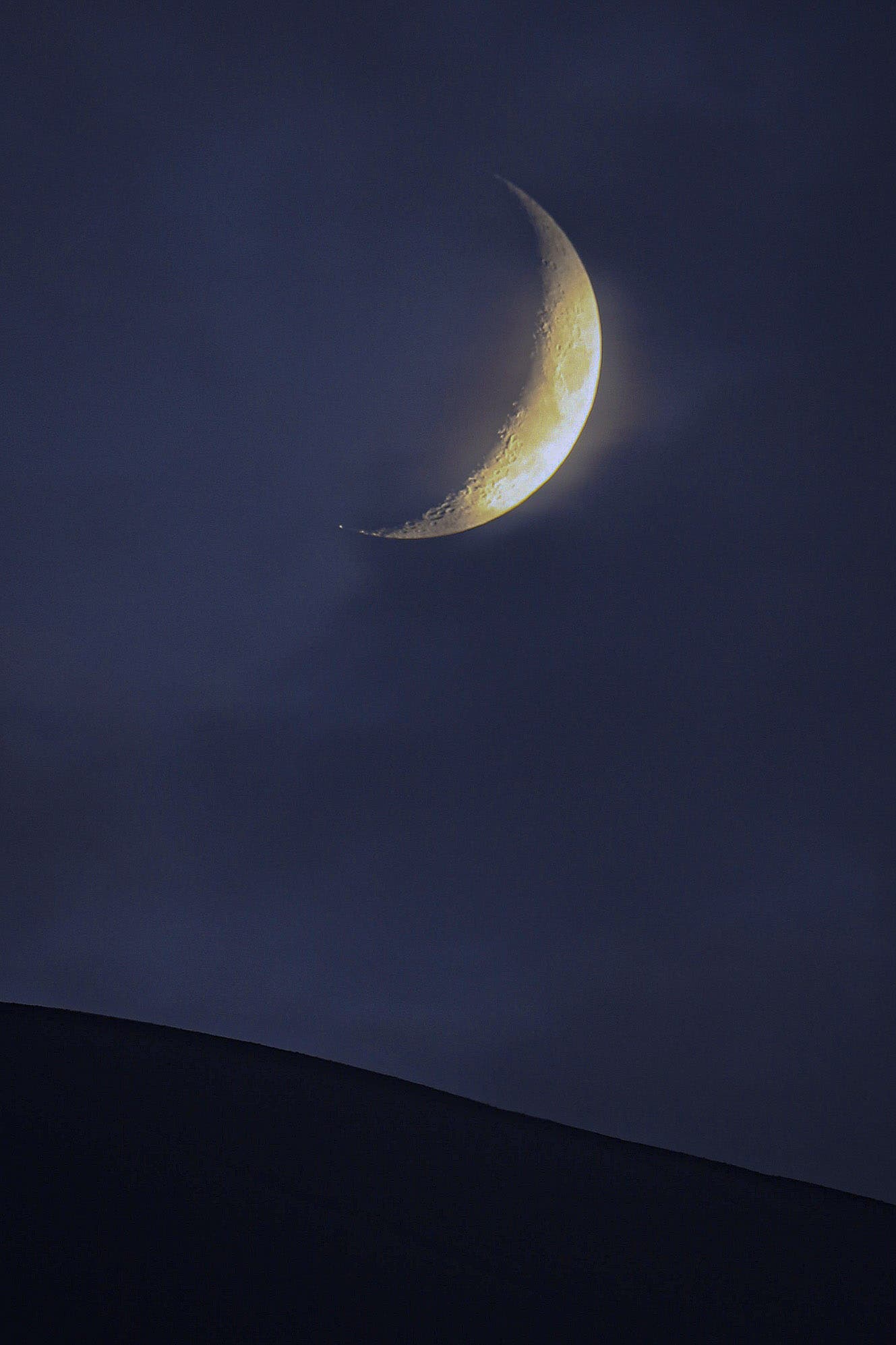 Crescent Moon setting over the  Etna volcano, the Mountain of Sicily 