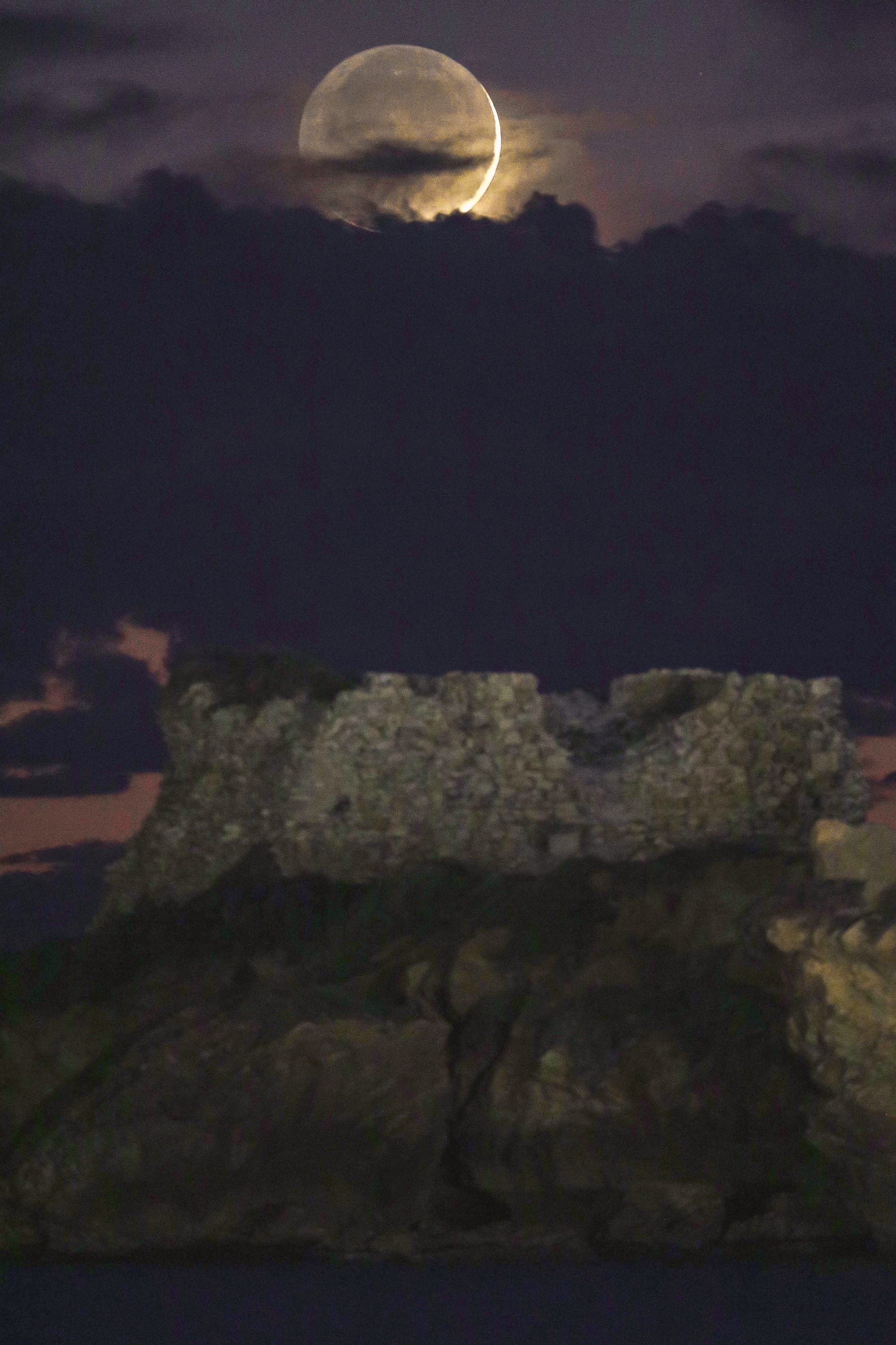 Crescent Moon 1,5 % sets over the ancient Vigliena tower Sicily Punta braccetto