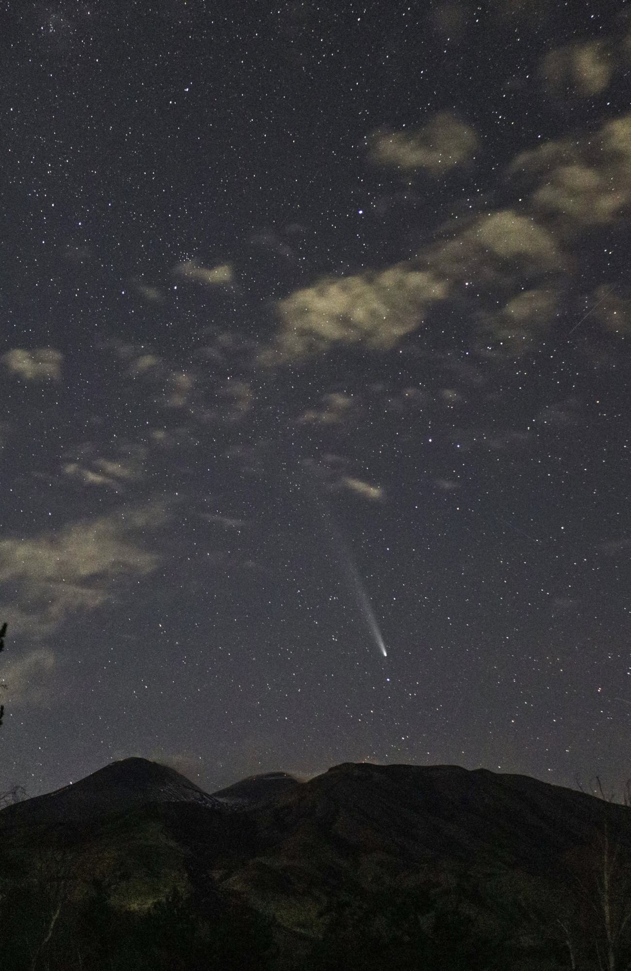 The great Comet Atlas setting on the volcano Etna MT 2000 