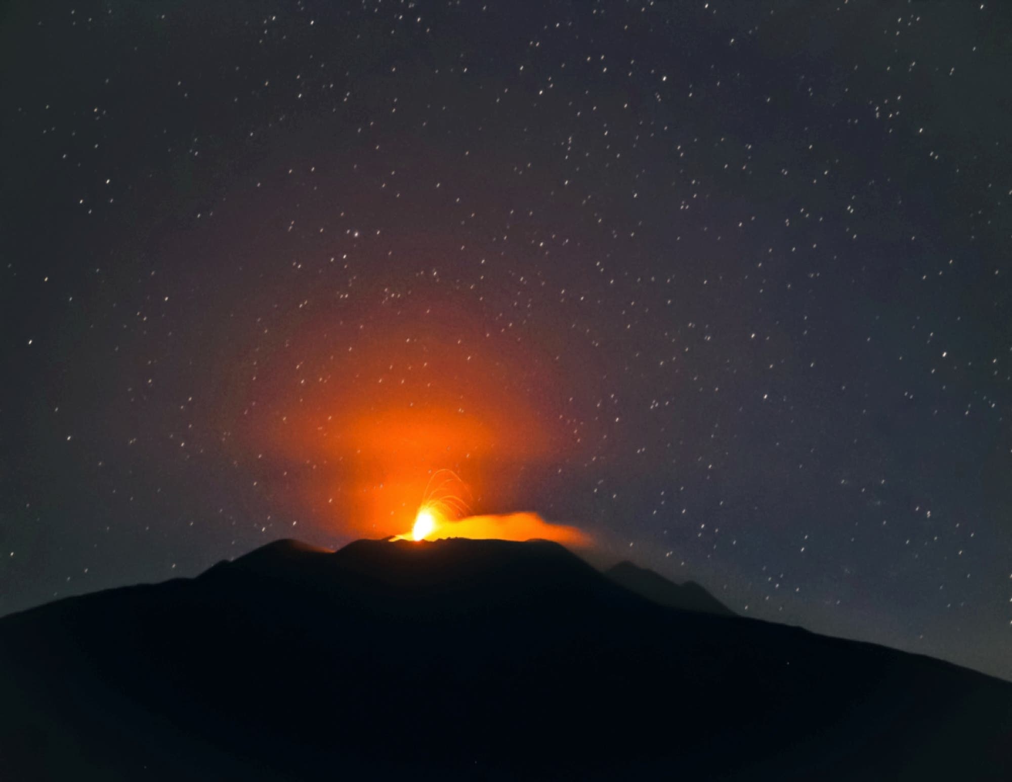 Pillar of light on mount Etna atmospheric effect Sicily, Italy 