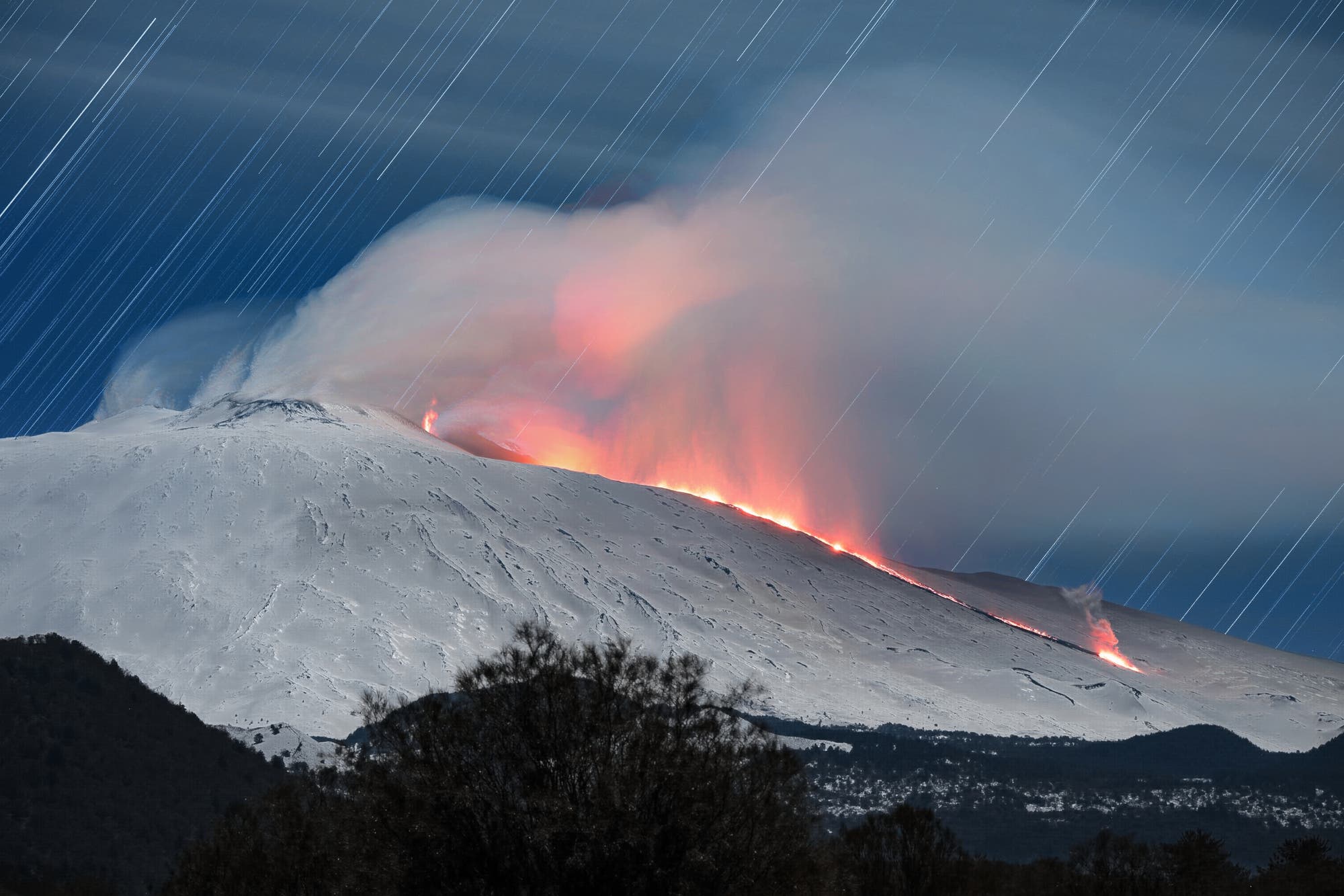 Star trails during the Etna eruption