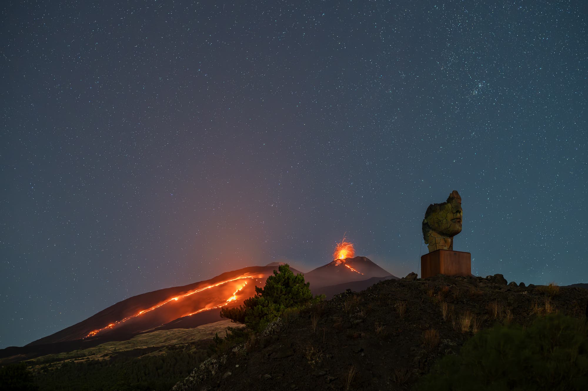 The cracked Theseus and the eruption of Etna under a starry sky