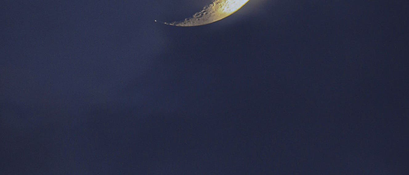 Crescent Moon setting over the  Etna volcano, the Mountain of Sicily 