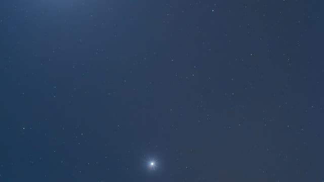 Jupiter, Moon, and Venus conjunct over the erupting volcano Etna