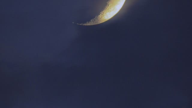 Crescent Moon setting over the  Etna volcano, the Mountain of Sicily 