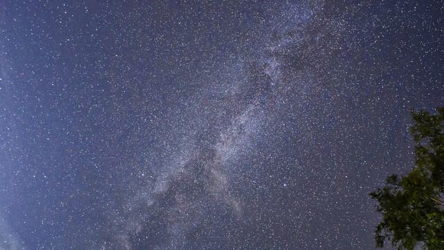 Milky way above erupting Etna volcano Sicily Italy 