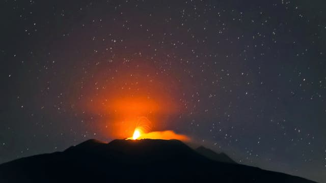 Pillar of light on mount Etna atmospheric effect Sicily, Italy 