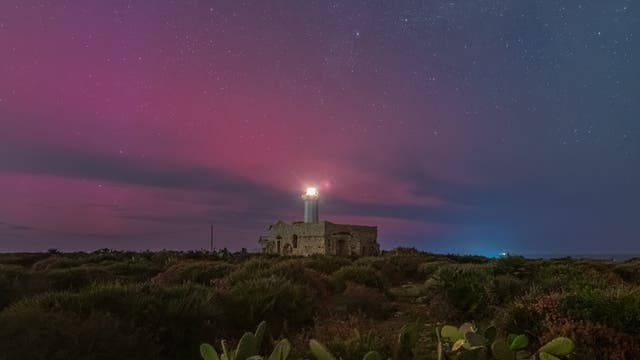 The stable red auroral arc (SAR) colors the sky above the Lighthouse