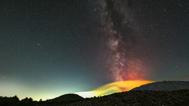The Milky Way over the Mount Etna eruption