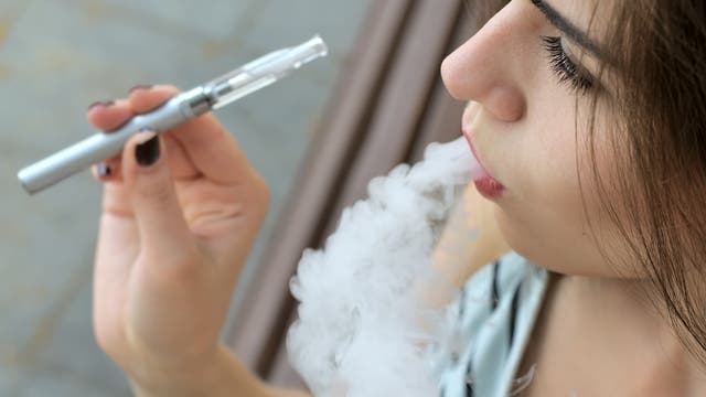 Eine junge Frau raucht eine E-Zigarette