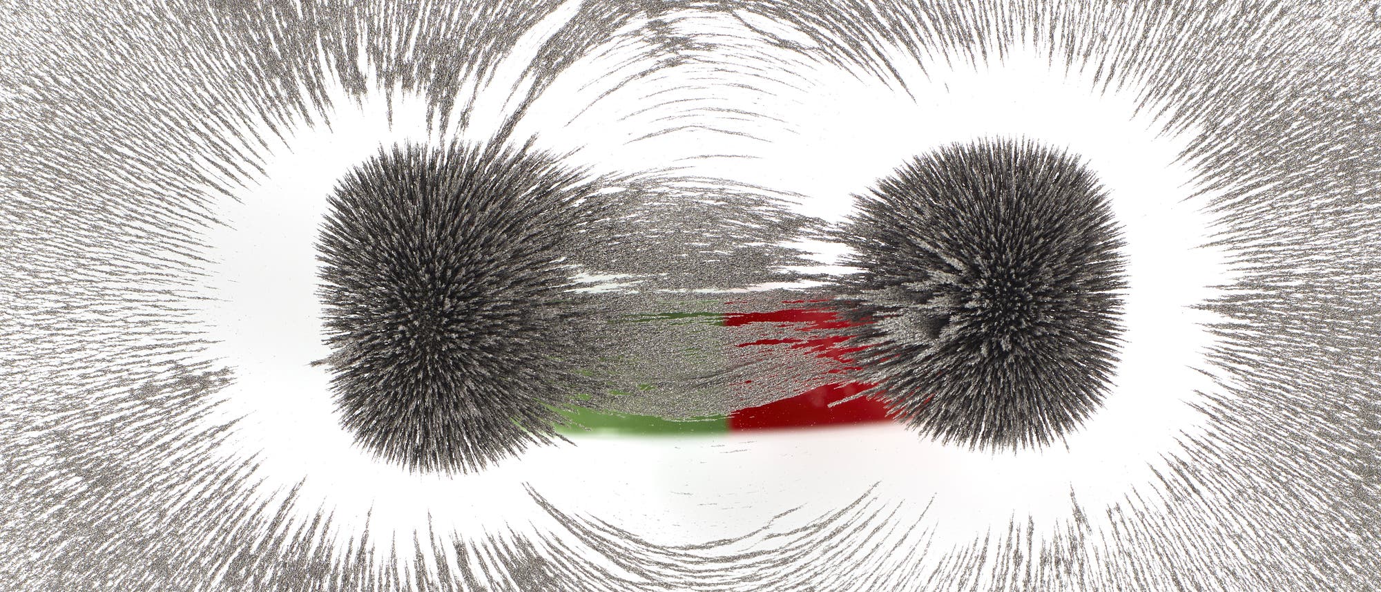 Anschauliches Schulexperiment: Ein Magnet richtet Eisenspäne aus. Anschauliches Schulexperiment: Ein Magnet richtet Eisenspäne aus.