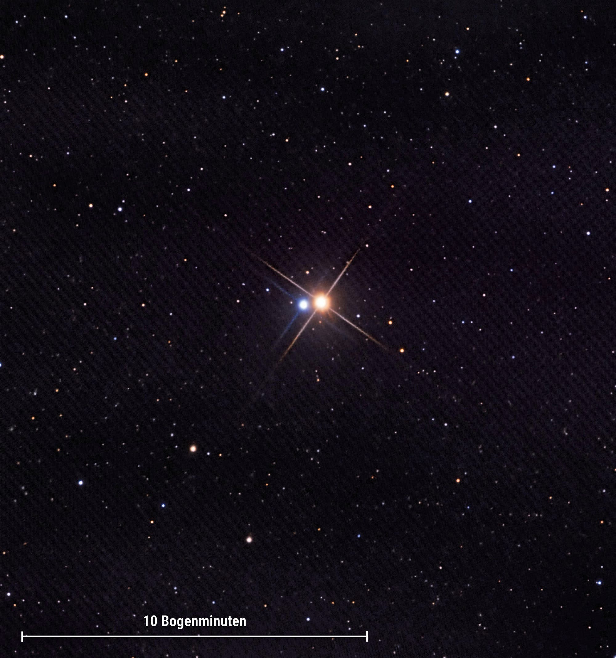 Foto der Komponenten A und B des Mehrfachsternsystems Albireo. Die beiden Sterne leuchten orange beziehungsweis blau.