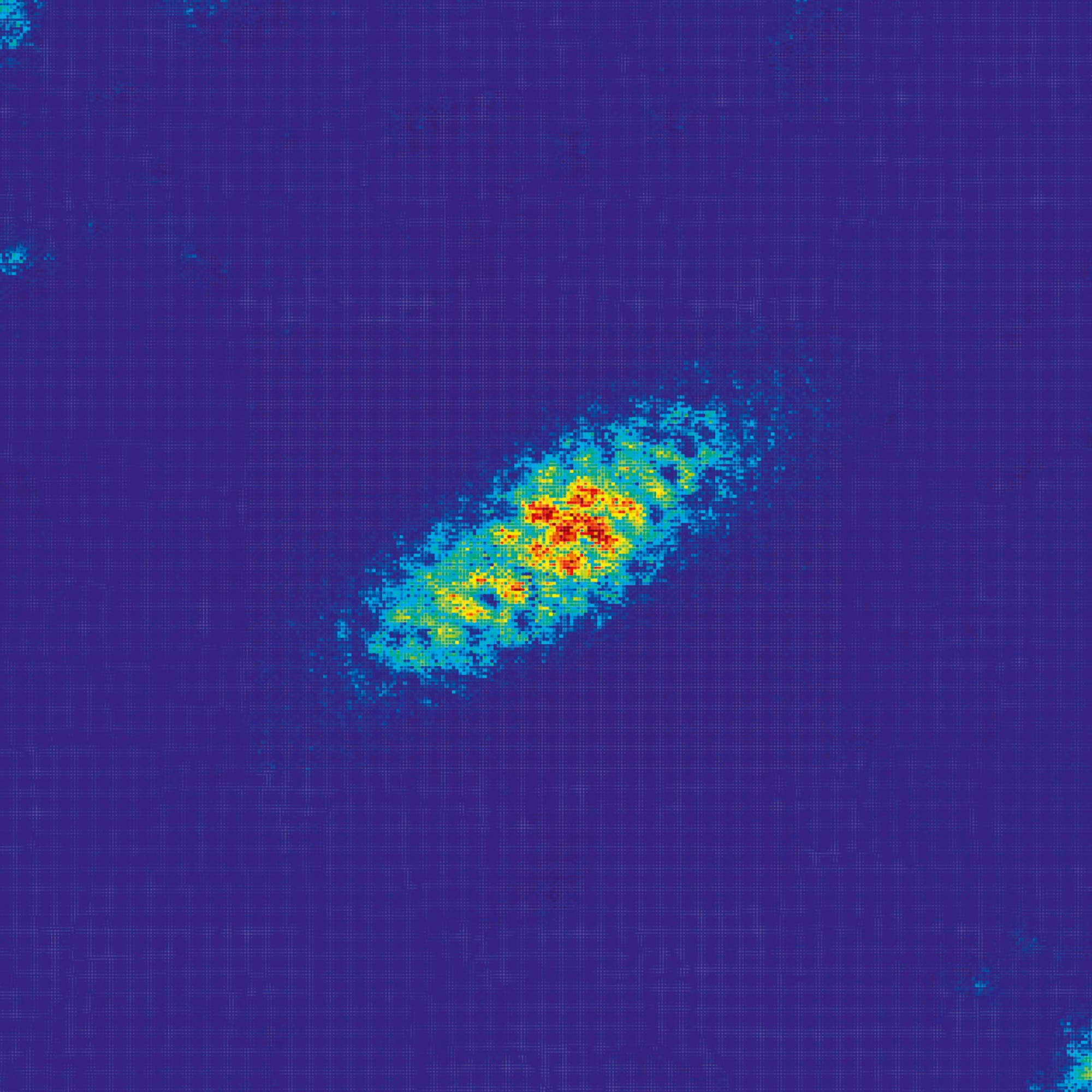 Eine Heatmap zeigt eine ovale Verteilung von Datenpunkten auf einem blauen Hintergrund. Die Farbskala reicht von Blau über Grün und Gelb bis Rot, wobei Rot die höchste Intensität darstellt. Die Daten konzentrieren sich in der Mitte der Abbildung, was auf einen zentralen Hotspot hinweist. Die umgebenden Bereiche sind überwiegend blau, was auf geringere Intensitäten hinweist.