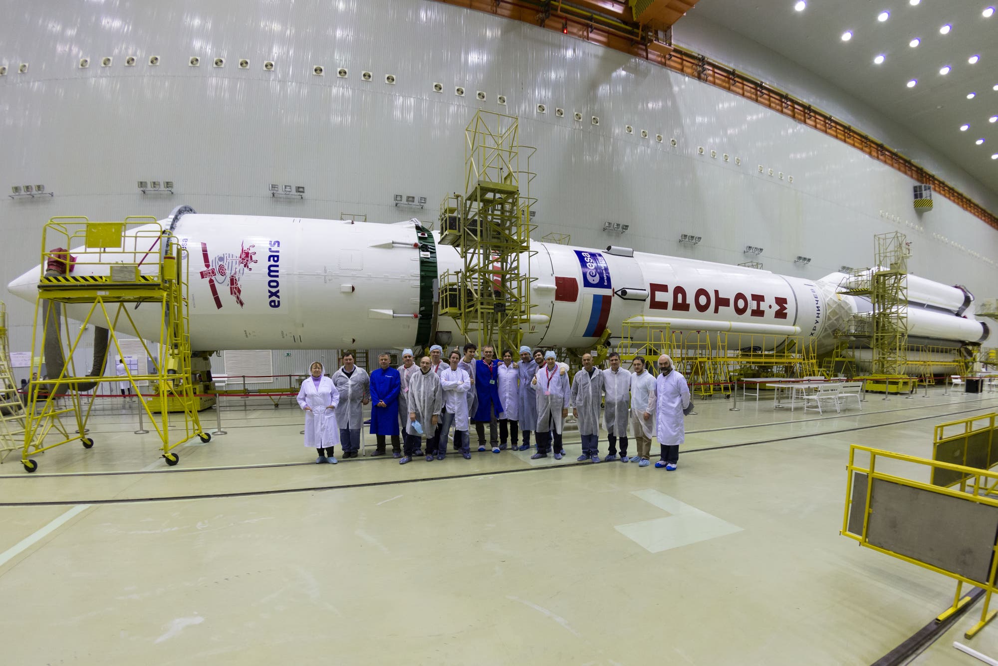 Die fertig montierte Proton-Rakete vor dem Transport zum Startplatz mit Startteam im Vordergrund