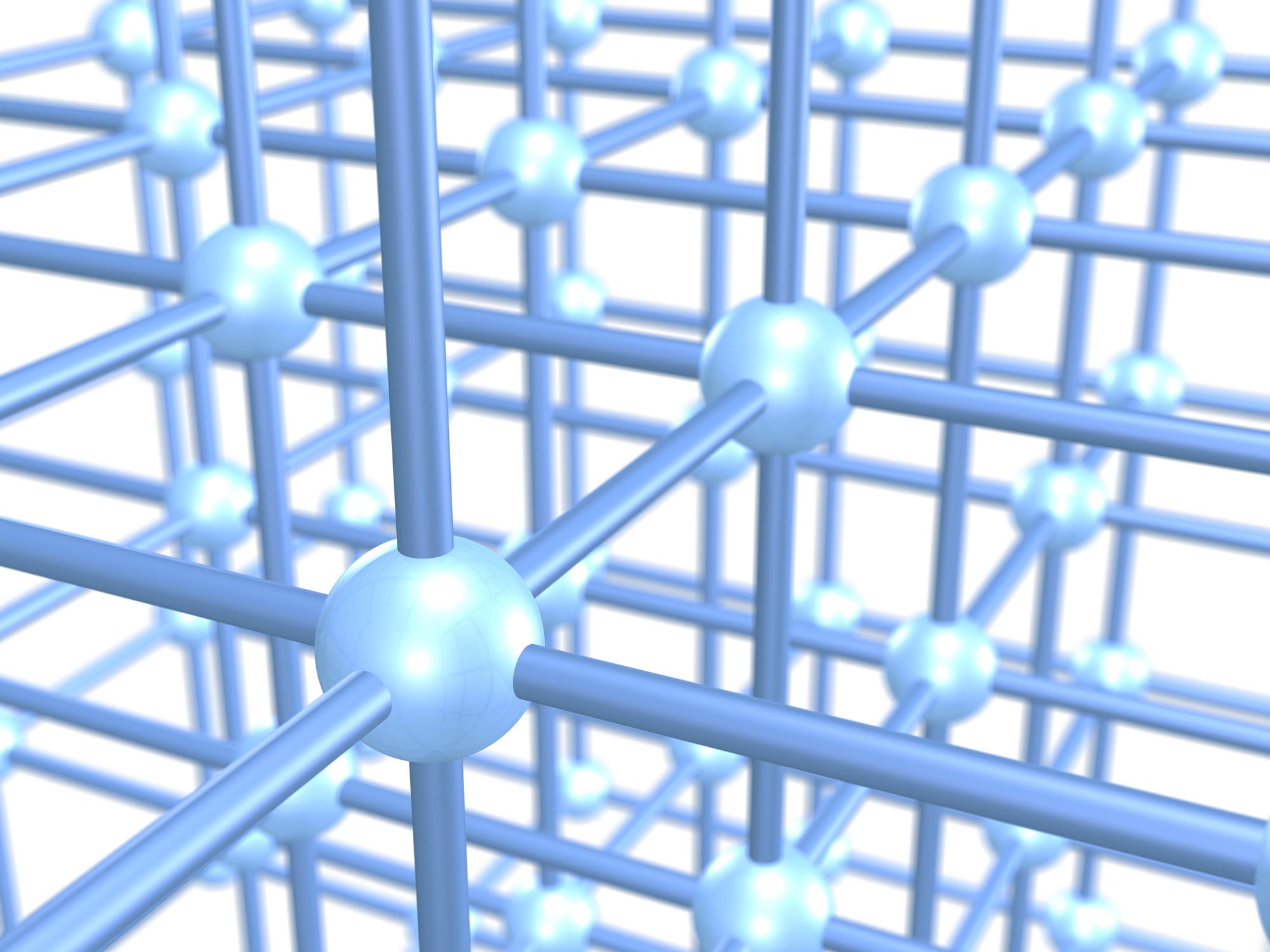 3D-Darstellung eines kubischen Gitters, bestehend aus kugelförmigen Knotenpunkten, die durch zylindrische Stäbe verbunden sind. Die Struktur zeigt ein regelmäßiges Muster, das die räumliche Anordnung und Verbindung der Elemente verdeutlicht. Die Farben variieren in Rottönen, was die Tiefe und Dimension der Darstellung betont.
