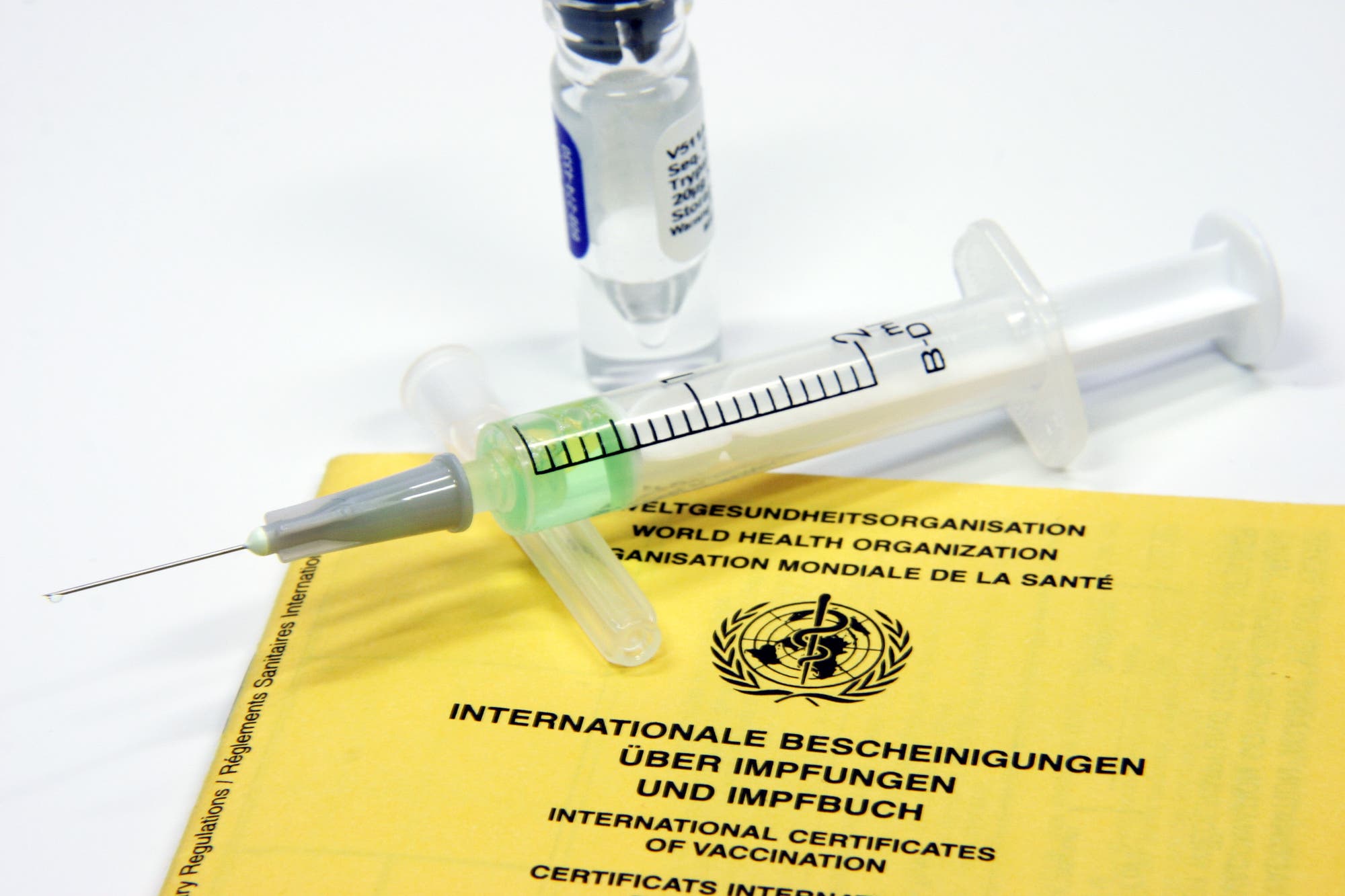 Spritze liegt auf Impfpass