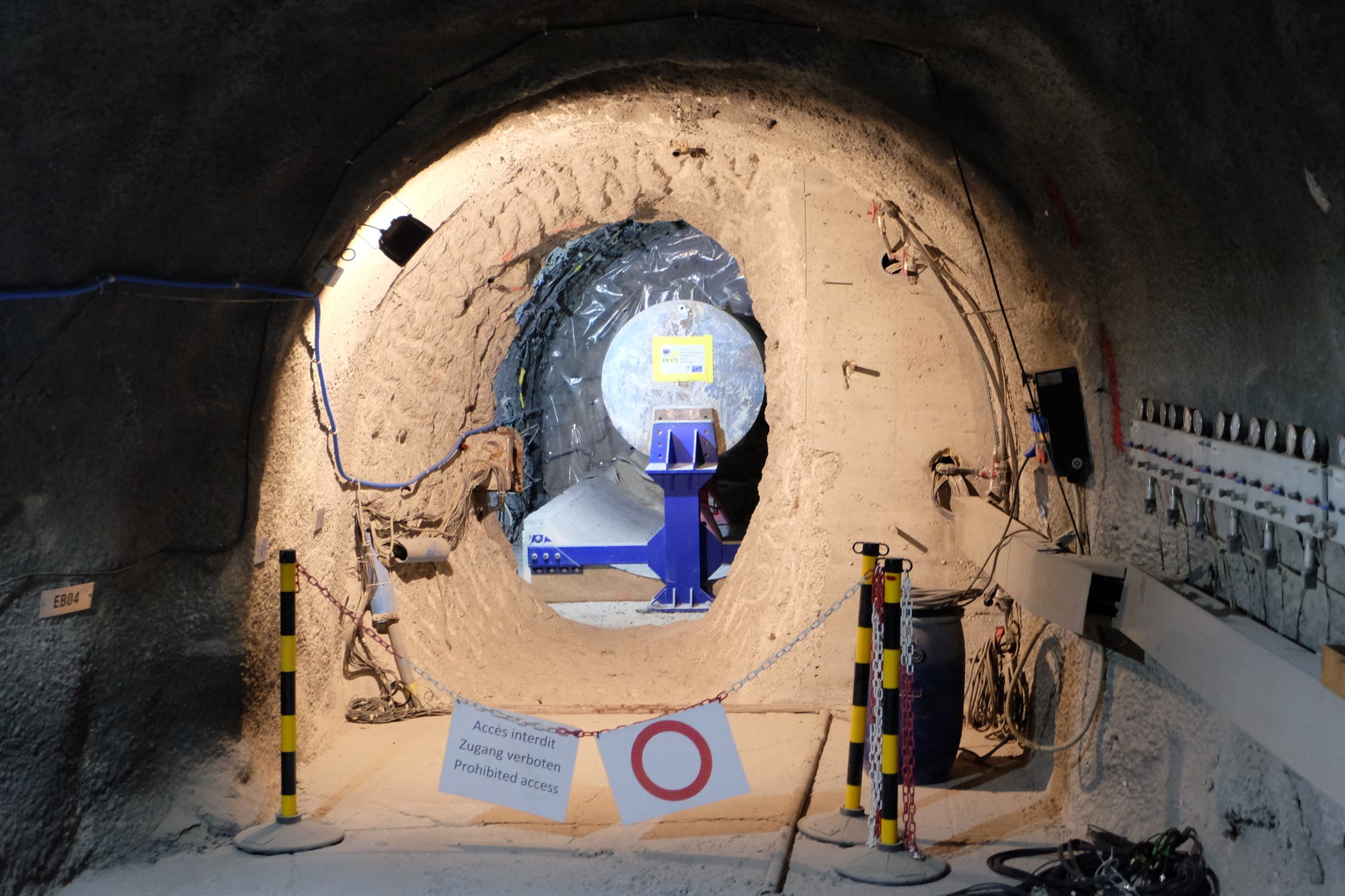 Ein Stahlzylinder von der Größe eines Atommüllfasses ist in einen unterirdischen Stollen eingebaut.