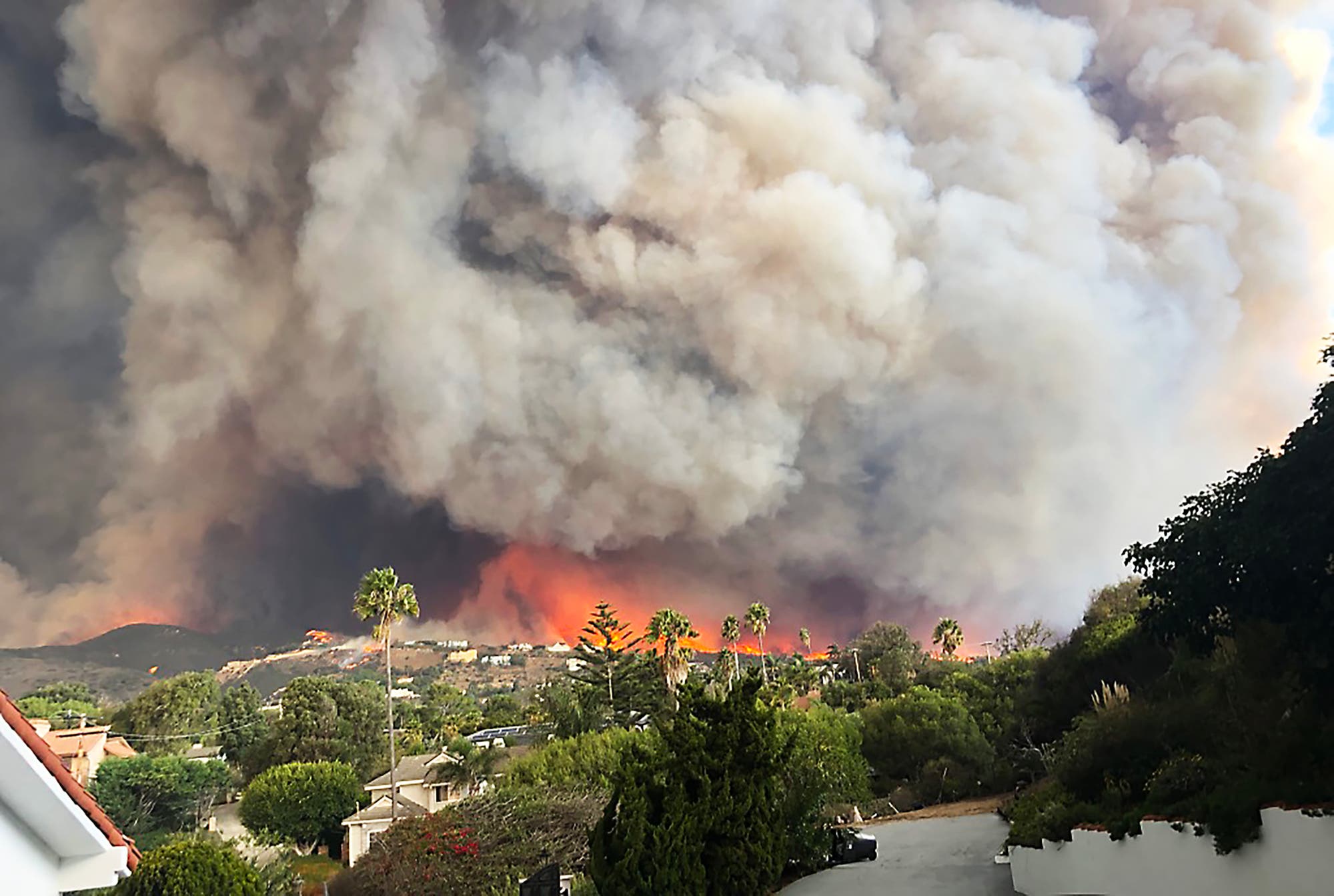 Riesige Rauchwolken über den Häusern einer kalifornischen Hügellandschaft