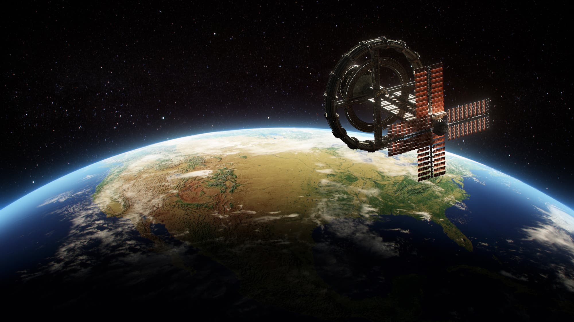 Eine futuristische, rotierende Raumstation schwebt im Orbit über der Erde