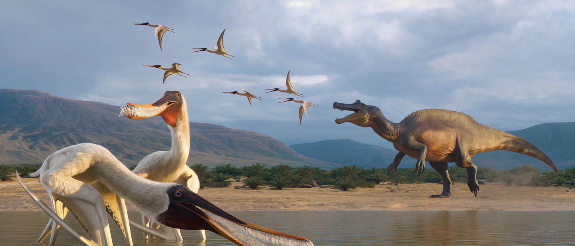 Eine Illustration einer prähistorischen Szene mit mehreren fliegenden und wasserlebenden Dinosauriern in einer Landschaft mit Bergen und Palmen im Hintergrund. Im Vordergrund stehen zwei große, vogelähnliche Kreaturen im Wasser, im Hintergrund ist ein großer, zweibeiniger Dinosaurier mit offenem Maul zu sehen. Der Himmel ist bewölkt, und die Szene vermittelt eine lebendige, dynamische Atmosphäre.