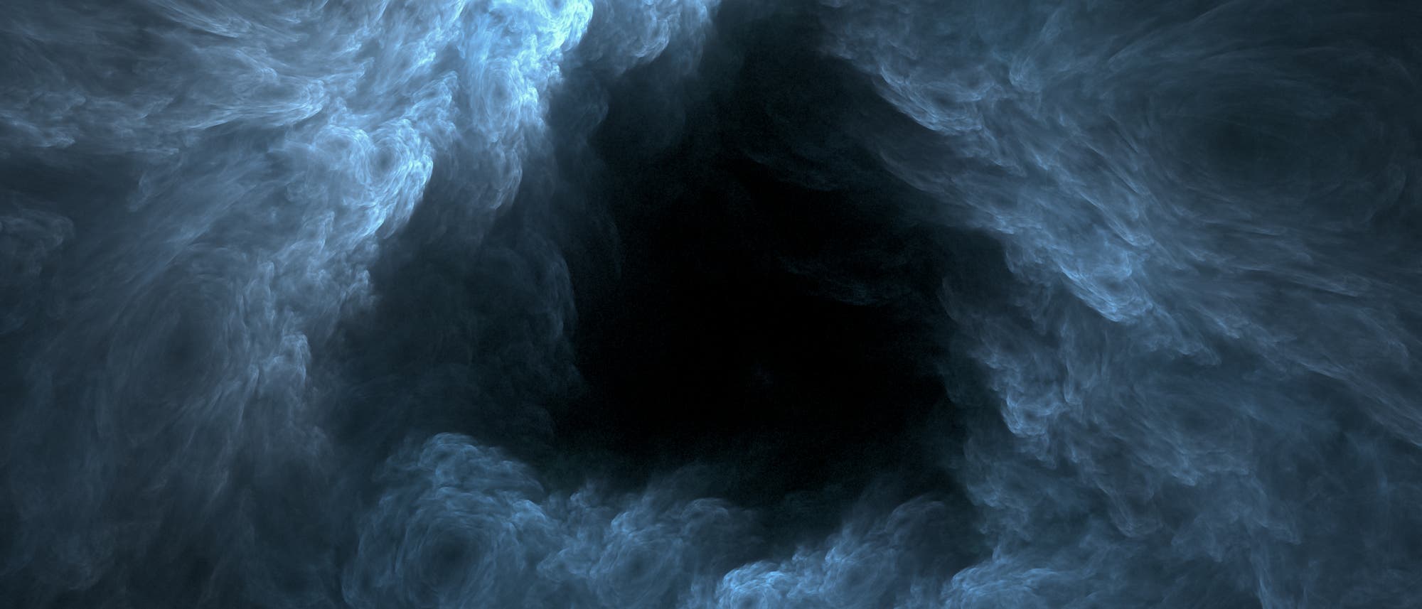 Eine dichte, wirbelnde Wolkenformation in bläulichen und grauen Tönen umgibt eine dunkle, zentrale Leere. Eine dichte, wirbelnde Wolkenformation in bläulichen und grauen Tönen umgibt eine dunkle, zentrale Leere.