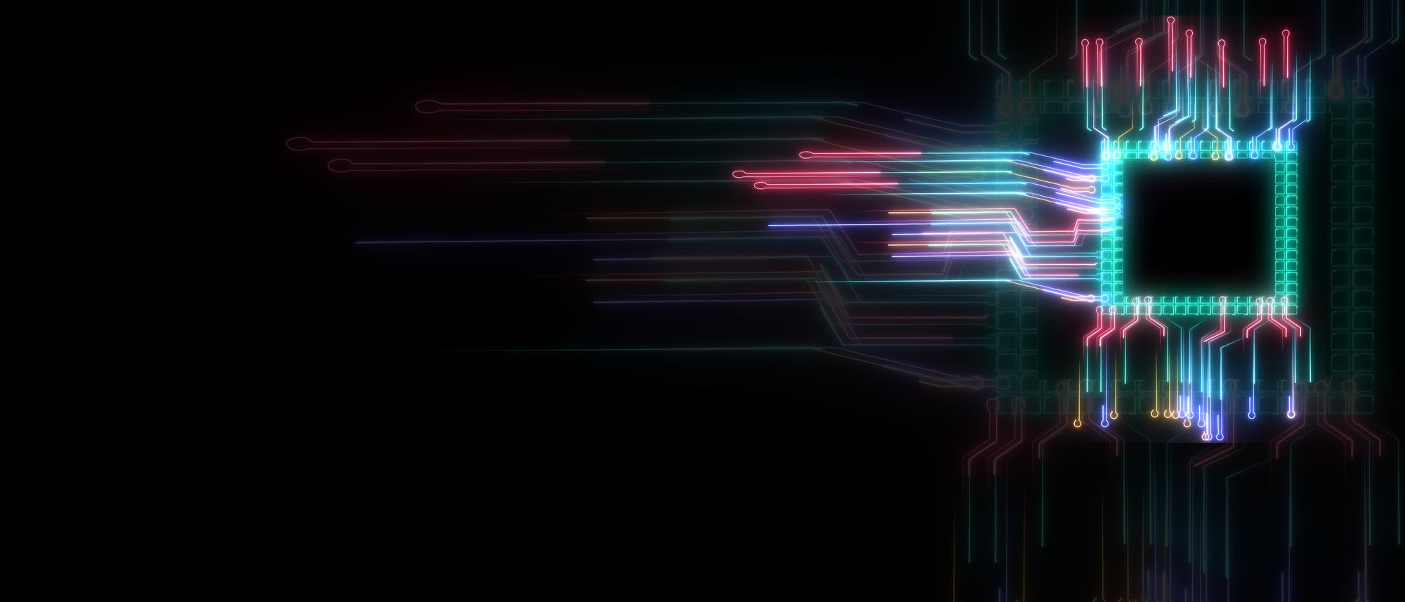 Ein leuchtender, abstrakter Schaltkreis auf schwarzem Hintergrund. Bunte Linien in Rot, Blau, Grün und Lila strahlen von einem zentralen, rechteckigen Chip aus, der rechts im Bild platziert ist. Diese Linien symbolisieren Datenströme und Konnektivität, die die digitale Kommunikation und Technologie darstellen. Ein leuchtender, abstrakter Schaltkreis auf schwarzem Hintergrund. Bunte Linien in Rot, Blau, Grün und Lila strahlen von einem zentralen, rechteckigen Chip aus, der rechts im Bild platziert ist. Diese Linien symbolisieren Datenströme und Konnektivität, die die digitale Kommunikation und Technologie darstellen.