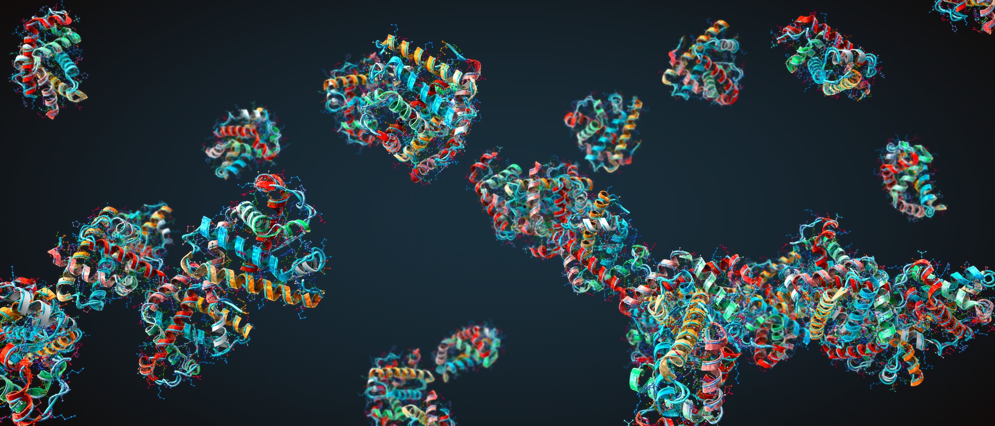Darstellung mehrerer 3D-Proteinstrukturen auf dunklem Hintergrund. Die Proteine sind in verschiedenen Farben dargestellt, um die unterschiedlichen Sekundärstrukturen wie Alpha-Helices und Beta-Faltblätter hervorzuheben. Die Abbildung zeigt die komplexe räumliche Anordnung der Proteine, die in Gruppen angeordnet sind. Die Farben und Formen verdeutlichen die Vielfalt der Proteinstrukturen und ihre potenziellen Interaktionen. Darstellung mehrerer 3D-Proteinstrukturen auf dunklem Hintergrund. Die Proteine sind in verschiedenen Farben dargestellt, um die unterschiedlichen Sekundärstrukturen wie Alpha-Helices und Beta-Faltblätter hervorzuheben. Die Abbildung zeigt die komplexe räumliche Anordnung der Proteine, die in Gruppen angeordnet sind. Die Farben und Formen verdeutlichen die Vielfalt der Proteinstrukturen und ihre potenziellen Interaktionen.