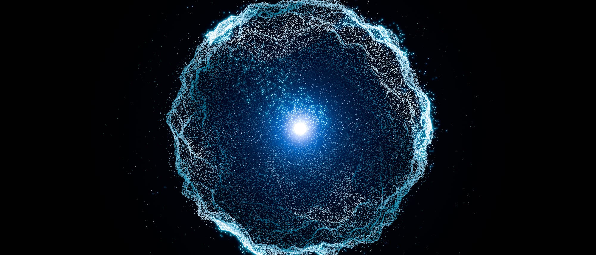 Eine leuchtende, blaue Kugel aus zahlreichen kleinen Partikeln schwebt in der Mitte eines schwarzen Hintergrunds. Die Partikel formen eine wellenartige, kreisförmige Struktur um einen zentralen, hellen Lichtpunkt. Die Anordnung erinnert an eine abstrakte Darstellung eines Energiefeldes oder einer Galaxie. Die Partikel scheinen sich dynamisch zu bewegen und erzeugen einen Eindruck von Tiefe und Bewegung. Eine leuchtende, blaue Kugel aus zahlreichen kleinen Partikeln schwebt in der Mitte eines schwarzen Hintergrunds. Die Partikel formen eine wellenartige, kreisförmige Struktur um einen zentralen, hellen Lichtpunkt. Die Anordnung erinnert an eine abstrakte Darstellung eines Energiefeldes oder einer Galaxie. Die Partikel scheinen sich dynamisch zu bewegen und erzeugen einen Eindruck von Tiefe und Bewegung.