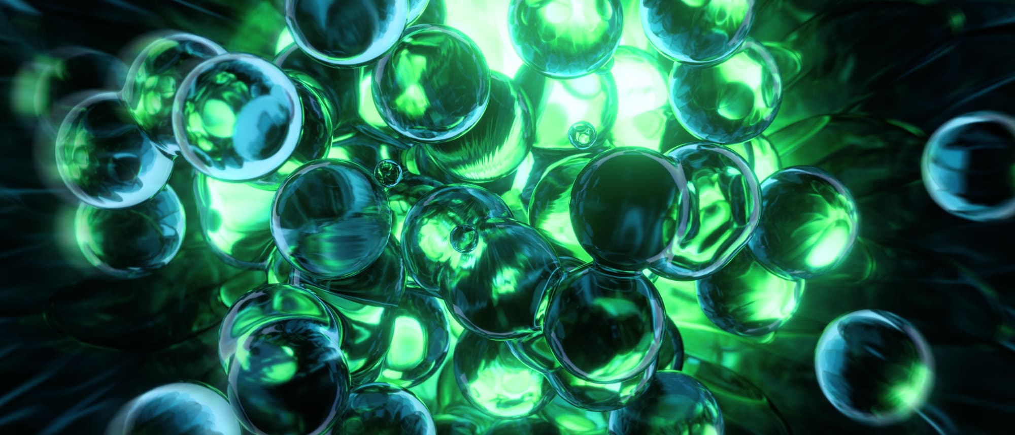 Eine 3D-Darstellung von transparenten Kugeln, die in einem leuchtenden gr&uuml;nen Licht schweben. Die Kugeln reflektieren das Licht und erzeugen einen schimmernden Effekt. Die Szene vermittelt ein Gef&uuml;hl von Tiefe und Bewegung, w&auml;hrend die gr&uuml;nen und blauen Farbt&ouml;ne eine futuristische Atmosph&auml;re schaffen.
