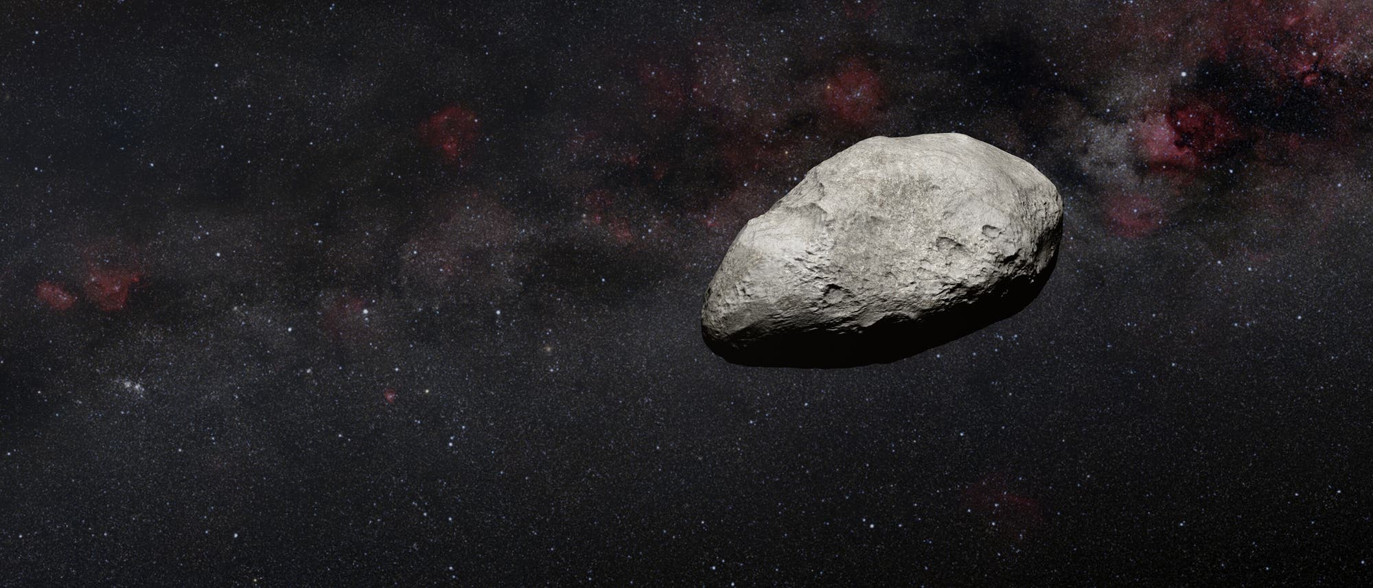 Illustration eines grauen, unförmigen Asteroiden, vor den dunklen Hintergrund des Alls.