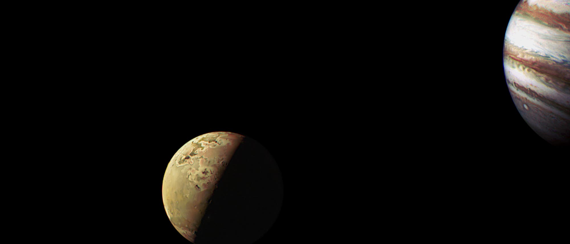 Aufnahme der Raumsonde Juno von Io mit Jupiter im Hintergrund