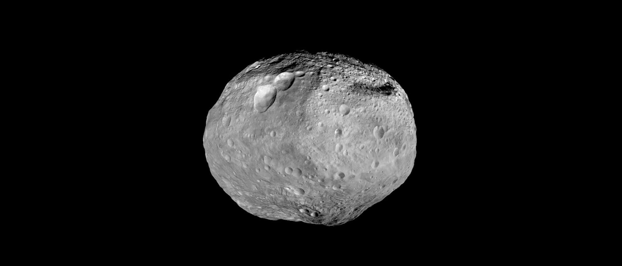 Ein grauer Asteroid mit unregelmäßiger Form und zahlreichen Kratern schwebt vor einem schwarzen Hintergrund. Die Oberfläche zeigt deutliche Unebenheiten und Vertiefungen, die auf eine komplexe geologische Geschichte hinweisen. Das Bild vermittelt einen Eindruck von der Beschaffenheit und Struktur des Asteroiden im Weltraum. Ein grauer Asteroid mit unregelmäßiger Form und zahlreichen Kratern schwebt vor einem schwarzen Hintergrund. Die Oberfläche zeigt deutliche Unebenheiten und Vertiefungen, die auf eine komplexe geologische Geschichte hinweisen. Das Bild vermittelt einen Eindruck von der Beschaffenheit und Struktur des Asteroiden im Weltraum.