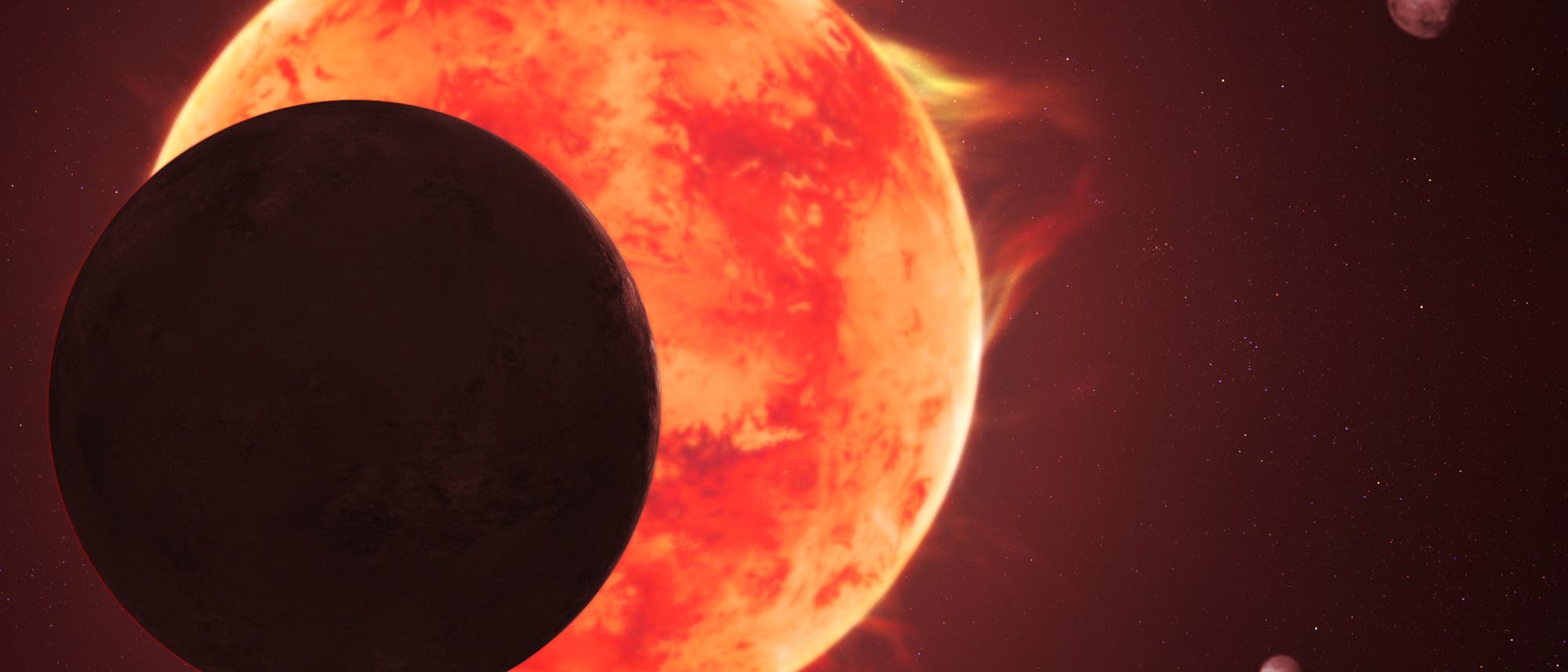 Konzeptdarstellung eines astronomischen Szenarios mit einem gro&szlig;en, leuchtend roten Stern im Hintergrund und einem dunklen Planeten im Vordergrund, der den Stern teilweise verdeckt. Zwei kleinere Himmelsk&ouml;rper sind im rechten Bereich des Bildes zu sehen. Der Hintergrund ist mit Sternen &uuml;bers&auml;t.