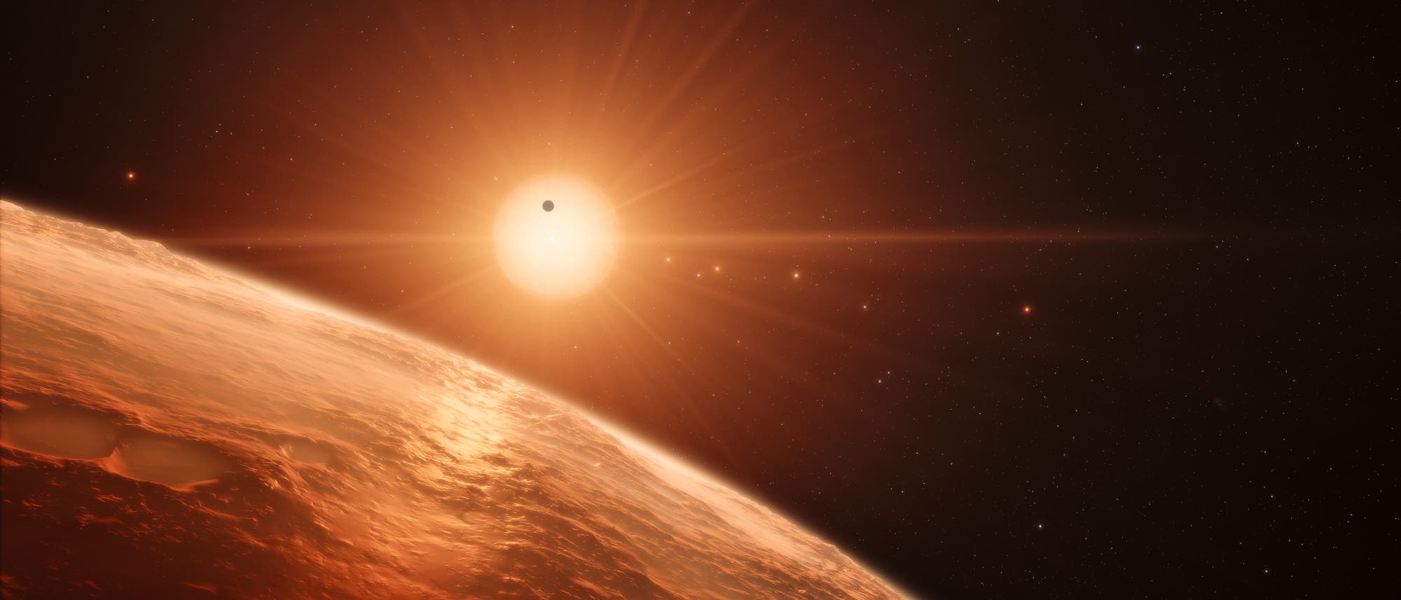 Sieben Welten um den roten Zwergstern TRAPPIST-1 (künstlerische Darstellung)