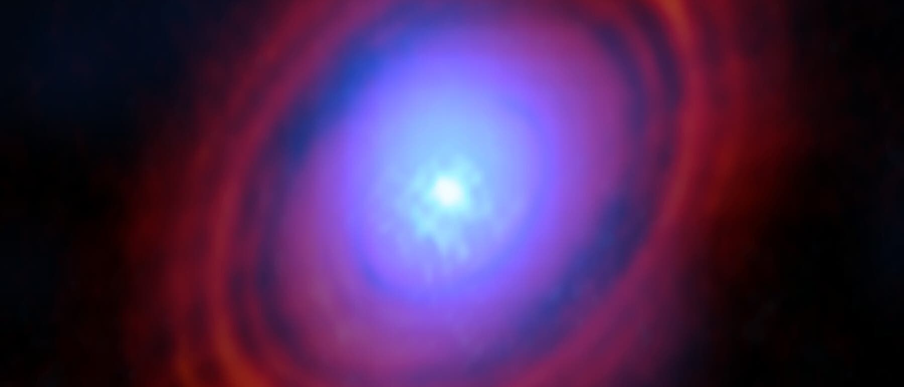Falschfarbenbild der Scheibe um den Stern HL Tauri. Man erkennt ringförmig angeordnete Lücken in der roten Scheibe aus Staub, während der Wasserdampf, dargestellt in blau, sich eher im Zentrum konzentriert.