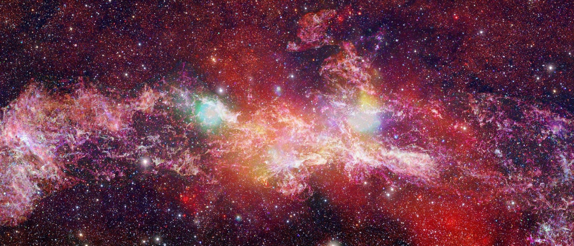 Ein farbenfrohes astronomisches Bild zeigt eine dichte Ansammlung von Sternen und leuchtenden Gaswolken im Weltraum. Die Wolken erscheinen in verschiedenen Farben wie Rosa, Rot und Gelb, was auf unterschiedliche chemische Zusammensetzungen und Temperaturen hinweist. Im Hintergrund ist ein sternenreicher Himmel zu sehen, der die Weite des Universums verdeutlicht. Dieses Bild veranschaulicht die Komplexit&auml;t und Sch&ouml;nheit kosmischer Strukturen.