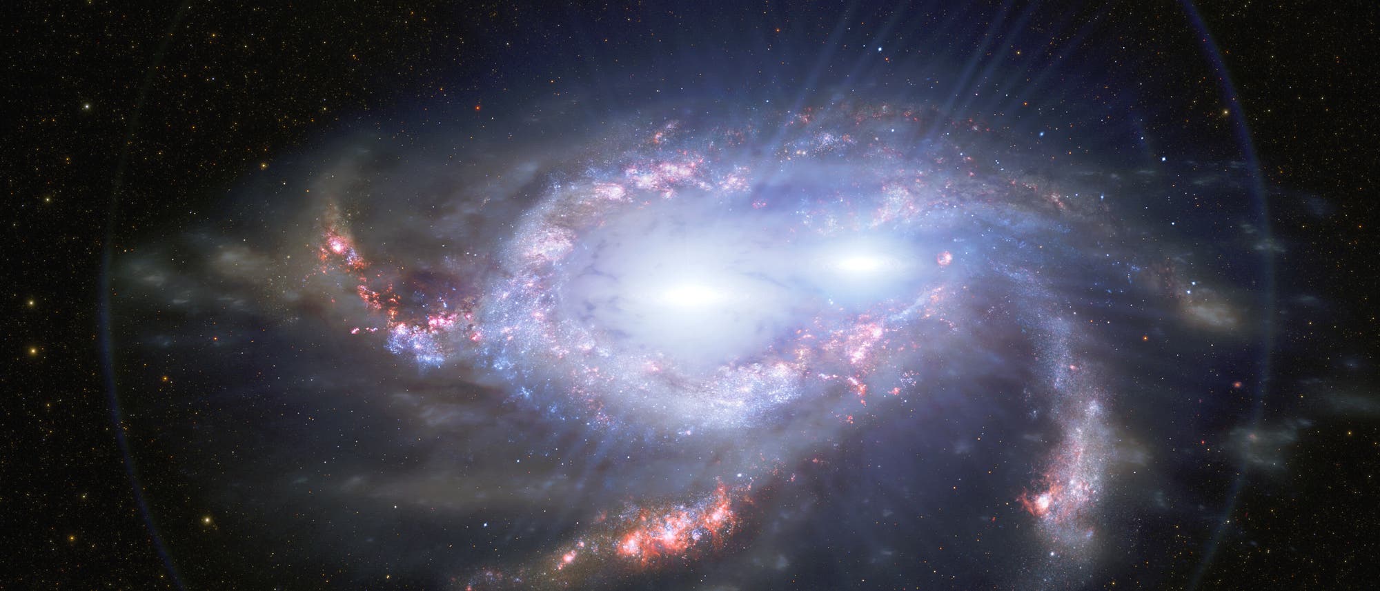 Una galaxia espiral en el espacio rodeada de numerosas estrellas. La galaxia muestra áreas azules y rosadas brillantes que indican regiones de formación estelar. El área central está brillantemente iluminada, lo que indica una alta densidad de estrellas o un centro galáctico activo. Los brazos en espiral son claramente visibles y se extienden majestuosamente hacia el espacio.