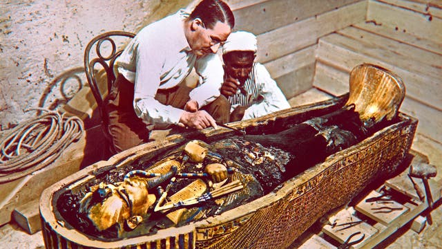 Howard Carter und ein Mitarbeiter untersuchen einen der Goldsärge von Tutanchamun.