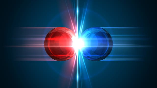 Eine rote und eine blaue Kugel treffen sich und am Kontaktpunkt gibt es einen Lichtblitz. Es soll eine Materie-Antimaterie-Kollision darstellen, tut das aber in wirklich jeder Hinsicht falsch. 