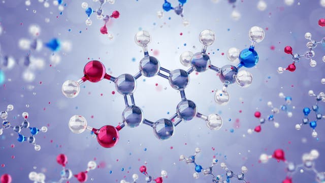 Glitzernde Darstellung der chemischen Molekülstruktur des Neurotransmitters Dopamin. Der Hintergrund ist verschwommen und in einem sanften Violett gehalten, was den Fokus auf die Molekülstruktur lenkt.