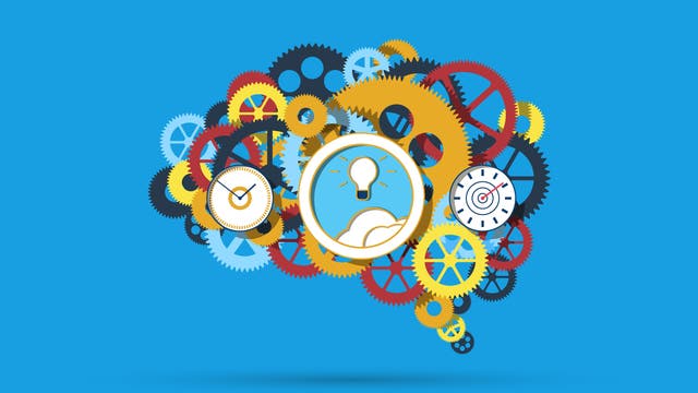 Eine künstlerische Illustration zeigt ein Gehirn, das aus bunten Zahnrädern in Blau, Rot und Gelb besteht. In der Mitte sind Symbole wie eine Glühbirne, ein Wecker und eine Zielscheibe zu sehen, die Kreativität, Zeitmanagement und Zielsetzung darstellen. Der Hintergrund ist einfarbig blau.