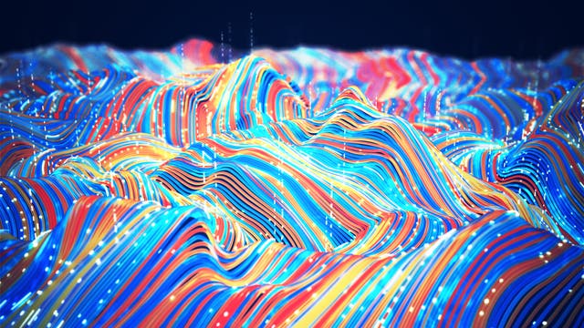 Eine 3-D-Darstellung zeigt eine wellenförmige Landschaft aus bunten, geschwungenen Linien in Blau, Rot, Gelb und Orange. Die Linien verlaufen parallel und erzeugen ein dynamisches Muster, das an topografische Karten erinnert. Kleine, leuchtende Punkte sind entlang der Linien verteilt, was einen digitalen oder technologischen Eindruck vermittelt. Der Hintergrund ist dunkel, wodurch die Farben der Linien hervorgehoben werden.