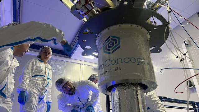 Ein Team von Wissenschaftlern und Technikern installiert den Kryostat