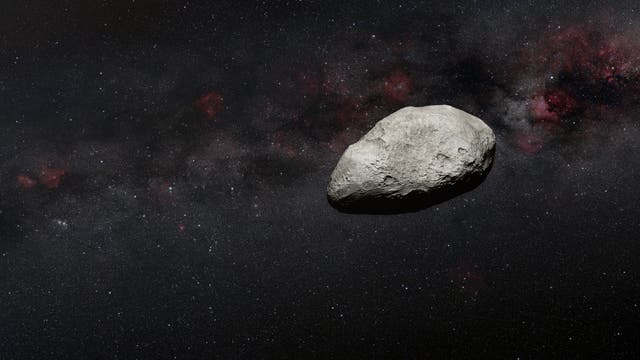 Illustration eines grauen, unförmigen Asteroiden, vor den dunklen Hintergrund des Alls.