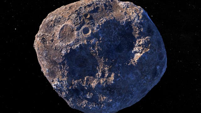 Eine künstlerische Darstellung des Asteroiden Psyche im Weltraum, umgeben von einem schwarzen Hintergrund mit kleinen, leuchtenden Sternen. Der Asteroid zeigt eine unregelmäßige, kraterübersäte Oberfläche in Brauntönen. In der unteren linken Ecke steht der Text "Illustration".
