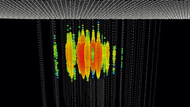 Das Bild zeigt eines der beiden höchstenergetischen Neutrinoereignisse, die kürzlich gemessen wurden. Jeder Lichtpunkt stellt einen Photosensor dar. Die Punktgröße ent- spricht der detektierten Stärke der Messsignale, die Farbe der Ankunftszeit, wobei rot früh und blau spät bedeutet.